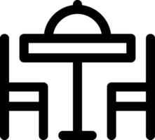 A black and white icon of a table and chairs vector