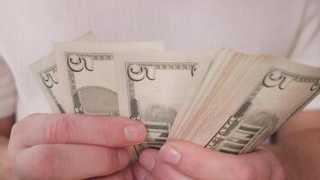 a close stack of five-dollar bills in the hands of a businessman video