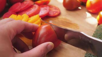 A near-red tomato is cut into slices video
