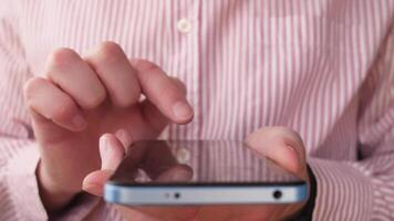 hands writing a message on a smartphone close video