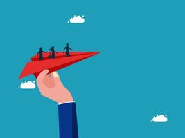 hand holding paper airplane with people on it vector