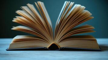 Pages rustle gently as the open book captures the serene atmosphere of a quiet study photo