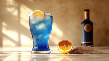 A vibrant blue drink sits on a marble surface, adorned with an orange slice photo