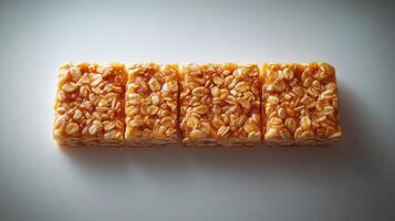 Nutritious granola bars lined up, showcasing their crunchy, golden texture photo