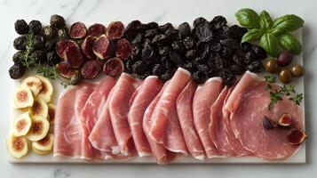 Sliced meats accompany fresh figs, olives, and herbs, creating a gourmet feast photo