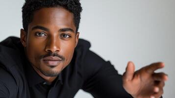 The young man radiates confidence and style with an engaging pose photo
