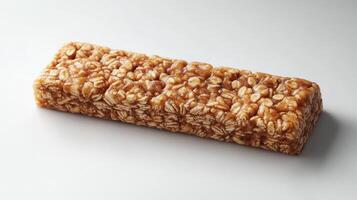 A chewy snack bar crafted from oats and honey rests elegantly on a clean surface photo
