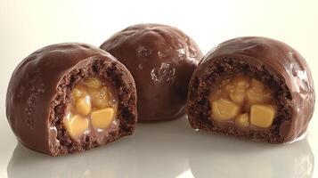 Chocolate spheres reveal a luscious caramel and apple filling, inviting indulgence photo