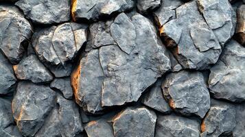 Rough volcanic rocks create an intricate pattern, blending earthy tones and textures photo