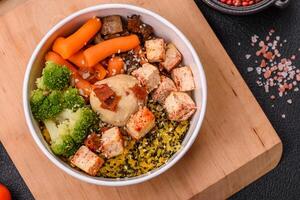 Colorful vegan vegetarian dish consists of tofu, broccoli, quinoa, mushrooms photo