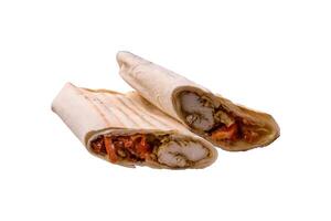 Roll with pita, meat, tomatoes, cheese, sauce, salt and spices photo