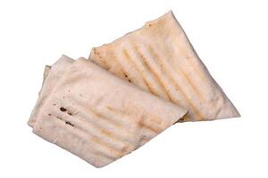 Roll with pita, meat, tomatoes, cheese, sauce, salt and spices photo