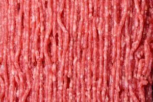 Fresh raw ground beef with salt, spices and herbs photo