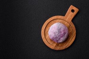 Delicious colorful asian mochi sweets with rice dough shell and fruit filling photo