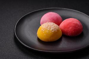 Delicious colorful asian mochi sweets with rice dough shell and fruit filling photo