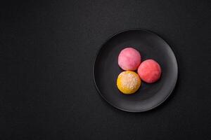 Delicious colorful asian mochi sweets with rice dough shell and fruit filling photo