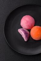 Delicious colorful asian mochi sweets with rice dough shell and fruit filling photo