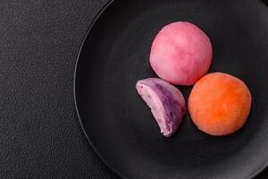 Delicious colorful asian mochi sweets with rice dough shell and fruit filling photo