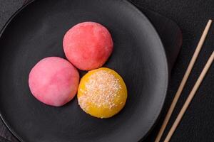 Delicious colorful asian mochi sweets with rice dough shell and fruit filling photo