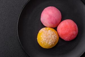 Delicious colorful asian mochi sweets with rice dough shell and fruit filling photo