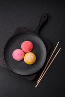 Delicious colorful asian mochi sweets with rice dough shell and fruit filling photo