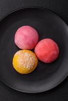 Delicious colorful asian mochi sweets with rice dough shell and fruit filling photo