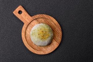Delicious colorful asian mochi sweets with rice dough shell and fruit filling photo
