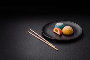 Delicious colorful asian mochi sweets with rice dough shell and fruit filling photo