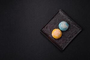 Delicious colorful asian mochi sweets with rice dough shell and fruit filling photo