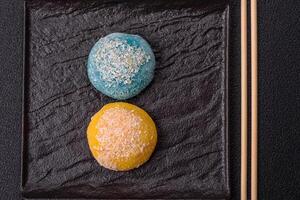 Delicious colorful asian mochi sweets with rice dough shell and fruit filling photo