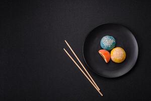 Delicious colorful asian mochi sweets with rice dough shell and fruit filling photo
