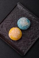 Delicious colorful asian mochi sweets with rice dough shell and fruit filling photo