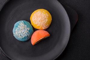 Delicious colorful asian mochi sweets with rice dough shell and fruit filling photo