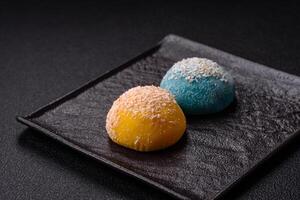 Delicious colorful asian mochi sweets with rice dough shell and fruit filling photo