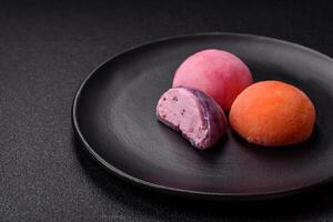 Delicious colorful asian mochi sweets with rice dough shell and fruit filling photo