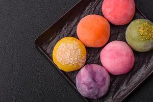 Delicious colorful asian mochi sweets with rice dough shell and fruit filling photo