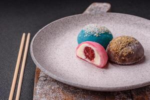 Delicious colorful asian mochi sweets with rice dough shell and fruit filling photo