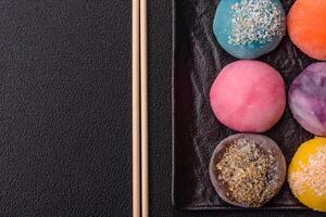 Delicious colorful asian mochi sweets with rice dough shell and fruit filling photo