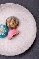 Delicious colorful asian mochi sweets with rice dough shell and fruit filling photo