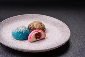 Delicious colorful asian mochi sweets with rice dough shell and fruit filling photo