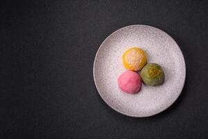 Delicious colorful asian mochi sweets with rice dough shell and fruit filling photo