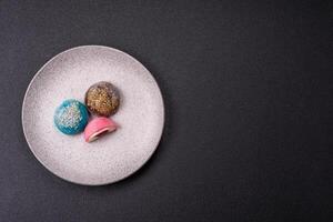 Delicious colorful asian mochi sweets with rice dough shell and fruit filling photo