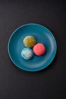 Delicious colorful asian mochi sweets with rice dough shell and fruit filling photo