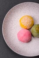 Delicious colorful asian mochi sweets with rice dough shell and fruit filling photo