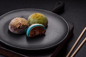 Delicious colorful asian mochi sweets with rice dough shell and fruit filling photo