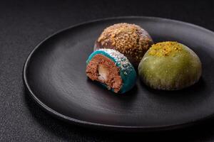 Delicious colorful asian mochi sweets with rice dough shell and fruit filling photo