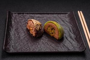 Delicious colorful asian mochi sweets with rice dough shell and fruit filling photo