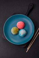 Delicious colorful asian mochi sweets with rice dough shell and fruit filling photo
