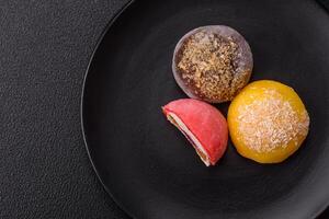 Delicious colorful asian mochi sweets with rice dough shell and fruit filling photo