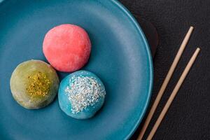 Delicious colorful asian mochi sweets with rice dough shell and fruit filling photo